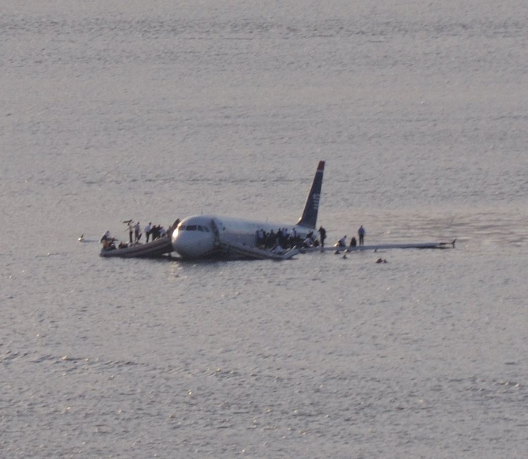 US Airways Flight 1549 floating on the Hudson River with passengers on the wings