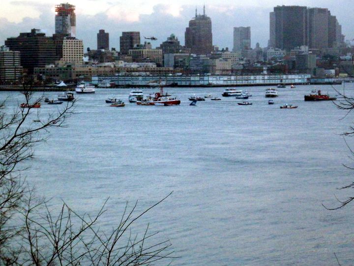 US Airways Flight 1549 afloat in the Hudson River with rescue boats alongside